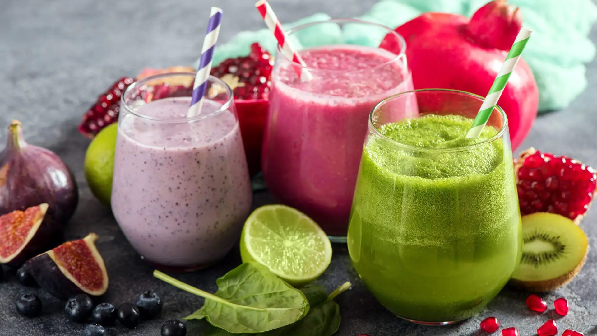 Colourful fruit smoothies in glasses, on a tray with fruit, perfect for wellbeing events