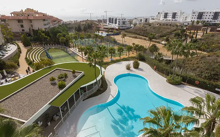 A view from a hotel balcony overlooking a swimming pool and distant views to the sea, in Southern Spain, for a company away day event