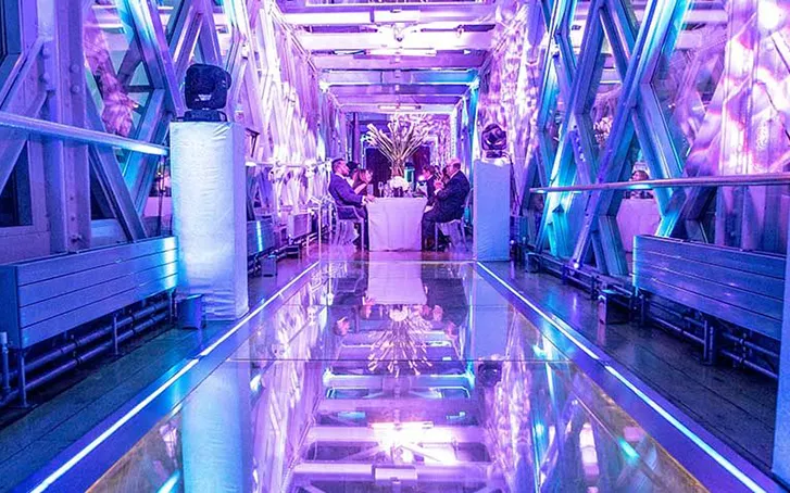 An internal view of the iconic tower bridge, featuring purple lighting for a corporate event