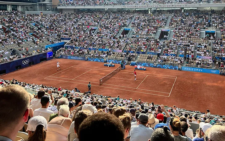 A clay tennis court pictured from the audience stands at the Paris Olympics 2024