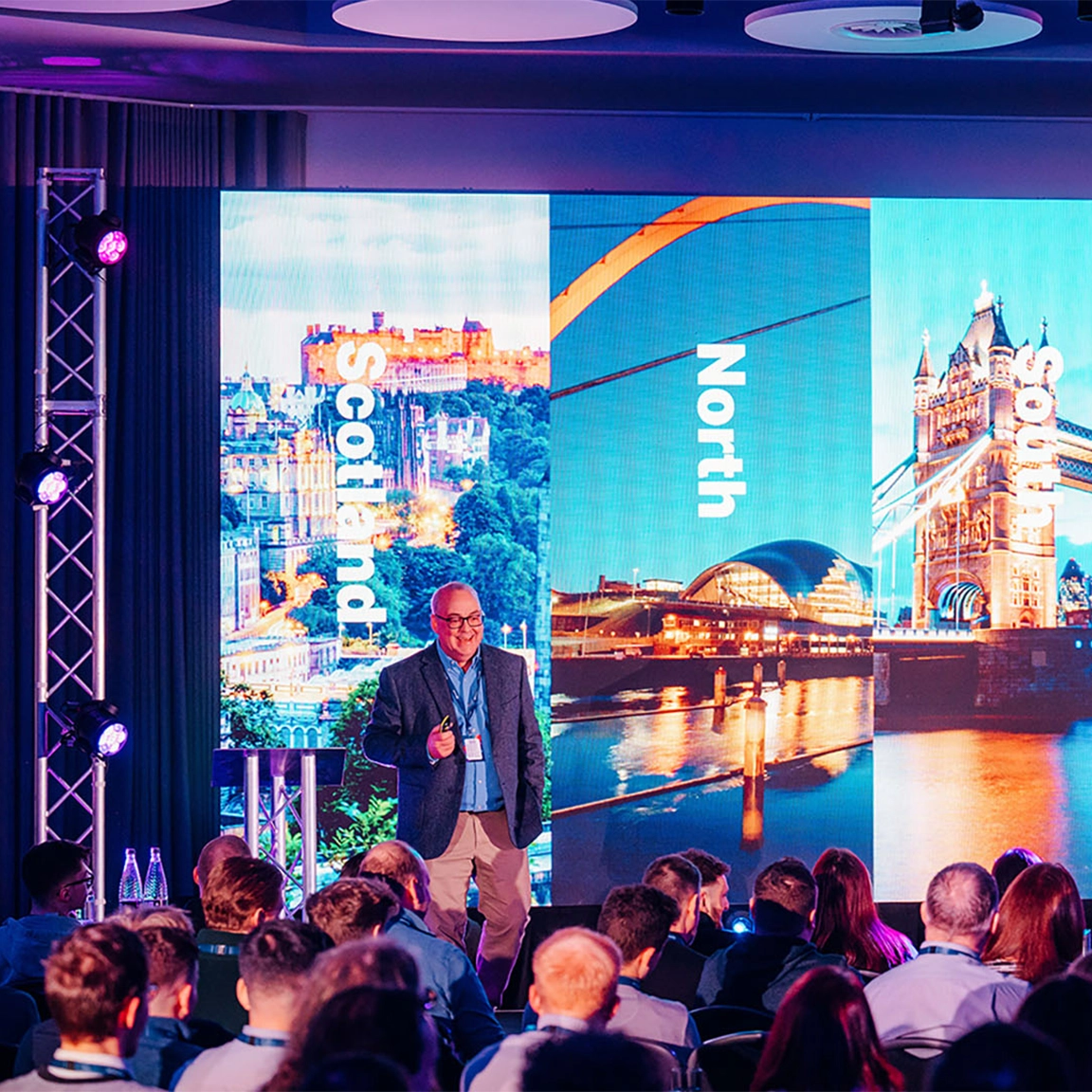 CEO presenting on stage at corporate kick-off event