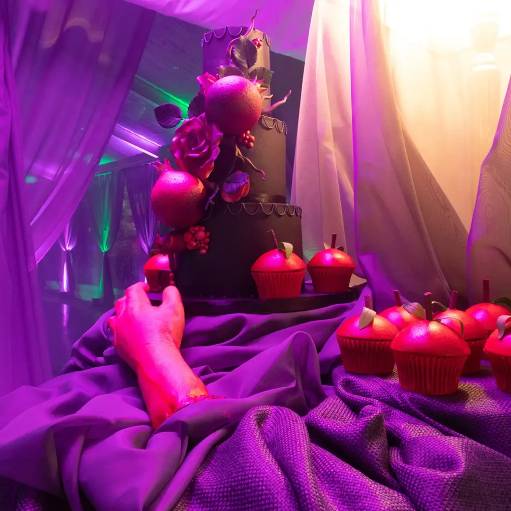 Cake with fake arm and poisoned apple cupcakes
