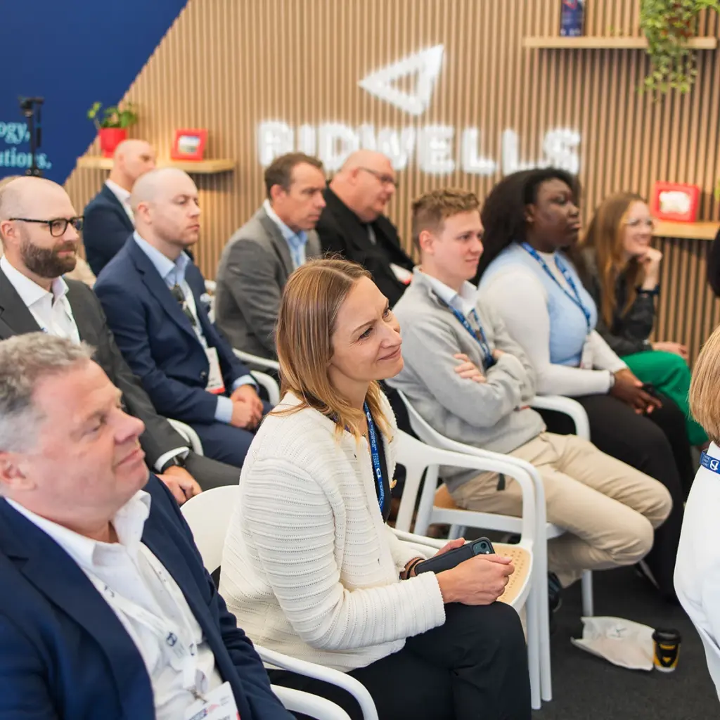 Engaged audience inside client marquee pavilion at expo