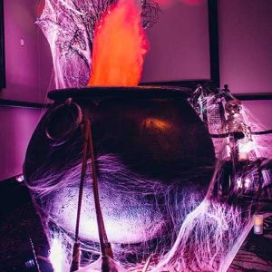 Event management for corporate Halloween dinner party - cobwebs with cauldron