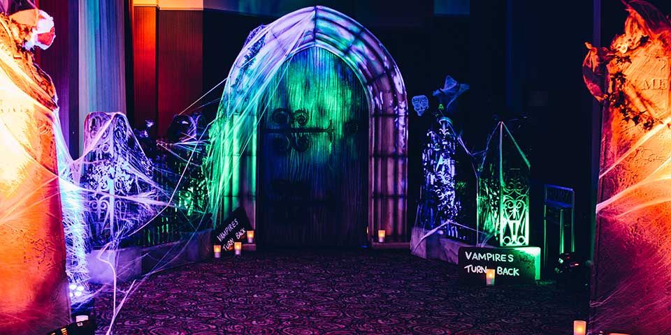 Event management for Halloween themed corporate party spooky scene with cobwebs