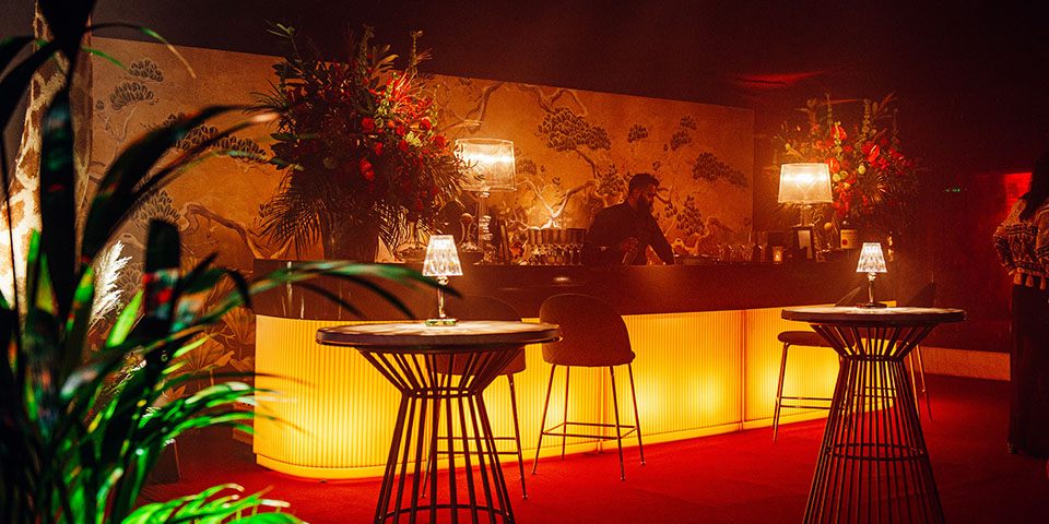 Art deco bar with mural backdrop at 50th birthday party
