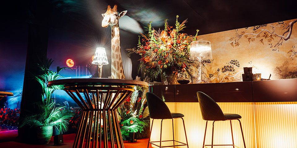 Art deco bar with stools and a life size giraffe