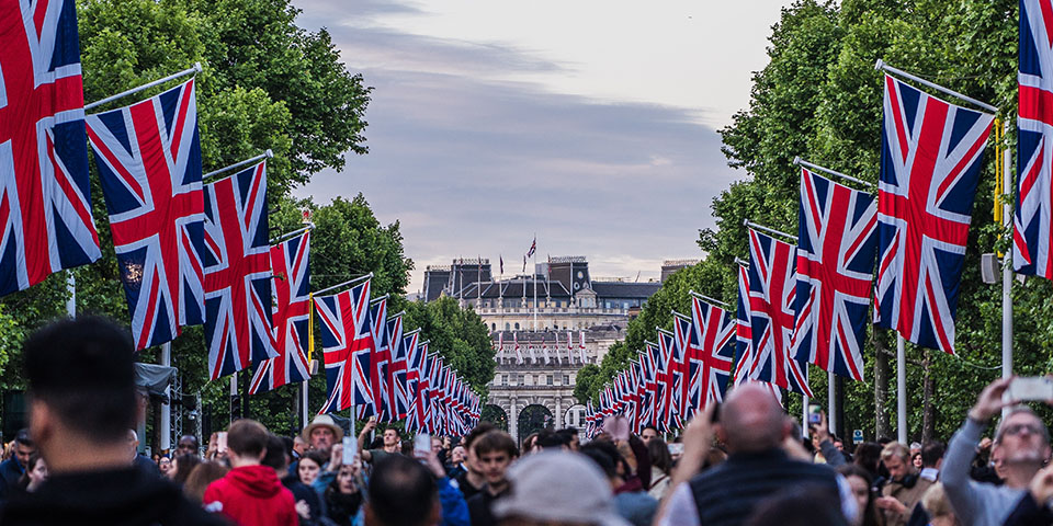 Coronation party in London with flag lined streets and crowds of party-goers