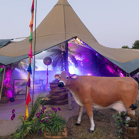 Summer party in London for gaming company with bespoke cow props and decor including tipi marquee